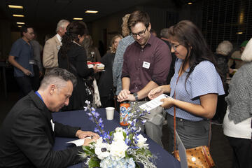 Jarret Keene signing books for fans during event