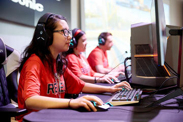 students in Rebel shirts working on computers