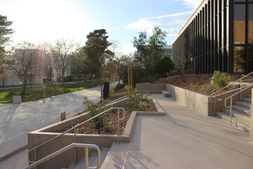 walkway showing ramps and stairs leading from a building at a higher elevation