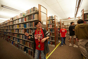 students in red shirts inside library