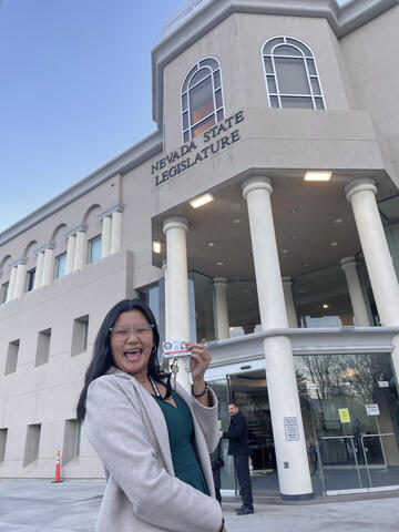 Caren Yap holding a badge
