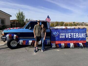 Dr. Anderson with wife in front of truck celebrating veterans