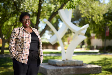 Angelique Burton in front of the white UNLV sculpture