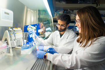 Dr. Amanda Osse alongside Aryan Shah, lab technician, in the lab.