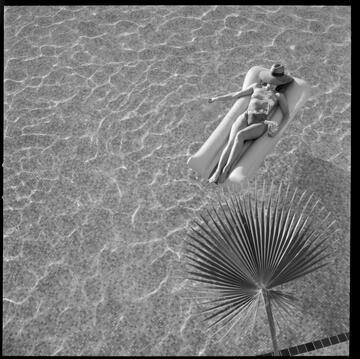 woman on raft floating in pool