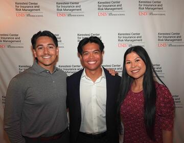 James Sarmiento with two finance alumni