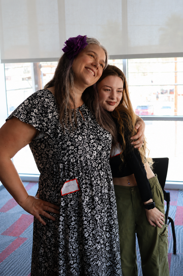mother and daughter pose for photo