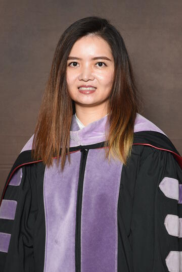 Jiaxin Hu in graduation robes