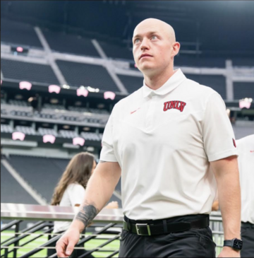 Brad Solomon on field with UNLV polo on