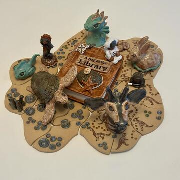 A sculpture of sea creatures around a book titled "A Day at the Library"
