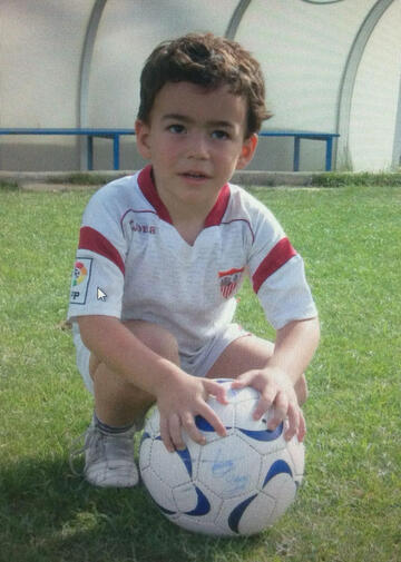 a young Manolo Vazquez in soccer uniform holding the ball