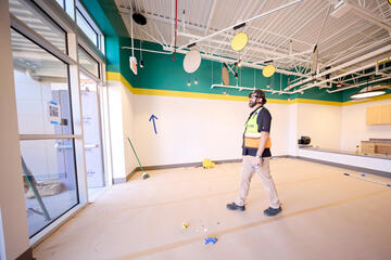 Branden Brumble walking through preschool construction space