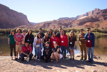 group of students in front of river basin