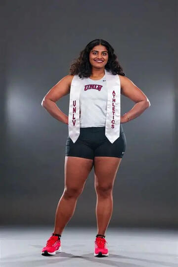 alumna wearing unlv athletic banner
