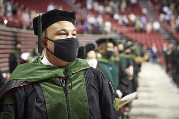 Kirk Kerkorian School of Medicine graduates line up to cross the commencement stage