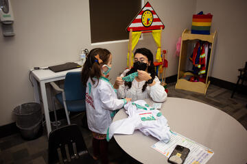 adult working with a child during a session