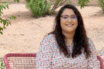 A woman sitting down at a bench