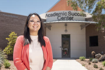 woman with glasses standing in front of Academic Success Center