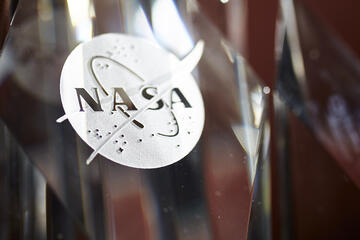 close up of NASA logo etched on crystal
