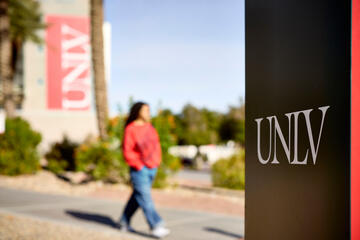 UNLV signage and a student walking in the background
