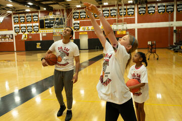 Jaineet (Jai) Chhabra, MD, and two “Dr. Jai Basketball: It’s for Everyone!” camp attendees practicing their basketball fundamentals.