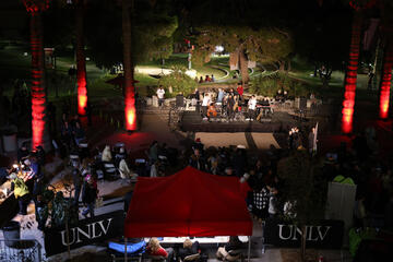 courtyard at night during an event with musicians performing on a stage