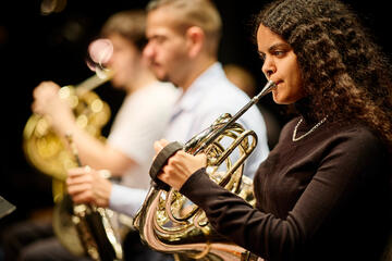 three musicians playing wind instruments