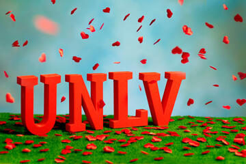 UNLV letters with red flower petals falling around it