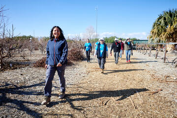 woman in blue jacket leads group of student volunteers at water conservation center in north las vegas valley