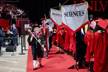 Satish carrying ceremonial mace during commencement ceremony
