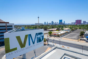 Aerial view of the Las Vegas Medical District sign with the Las Vegas skyline in the background.