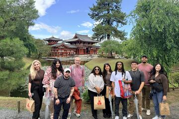 MBA students with a Japanese torii gate behind the group