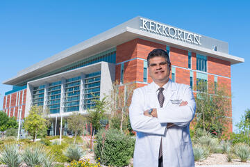 Dr. Robert Hernandez in front of the Kirk Kerkorian Medical Education Building.