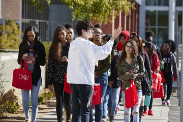 A UNLV student tour guide leads a group of Clark County School District students on a tour of UNLV's campus.