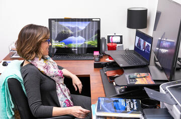 Michelle Paul, director of The PRACTICE Mental Health Clinic at UNLV, sits in front of her computer in her office to conduct a virtual meeting.