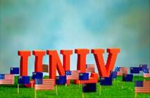 UNLV letters on grass with US and Nevada flags planted around the letters