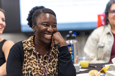 Adjoa Mensah smiling at a colleague