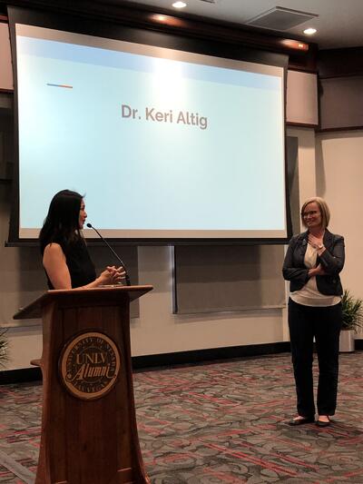 Dr. Lee (at the podium) introduces Dr. Altig