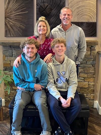 Picture of a family; husband and wife with their two sons