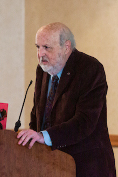 Professor William Speer speaking at a podium