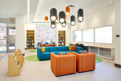 Reception area with couches and bookshelves