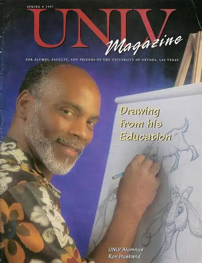 Photo of 90s UNLV Magazine cover with Ron Husband drawing cartoons and smiling at the camera