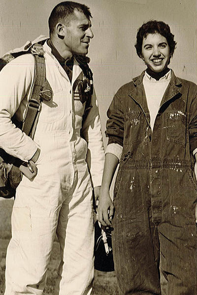 Vintage photo of a young Stephanie Wolf Hughes in a flight suit with unidentified flight instructor.