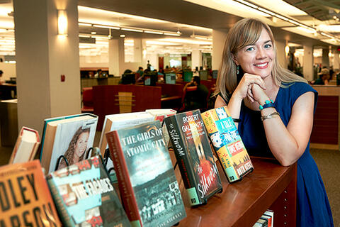 Melissa Bowles-Terry leaning on a bookcase