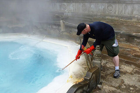 A man collecting samples at a Chinese hot springs