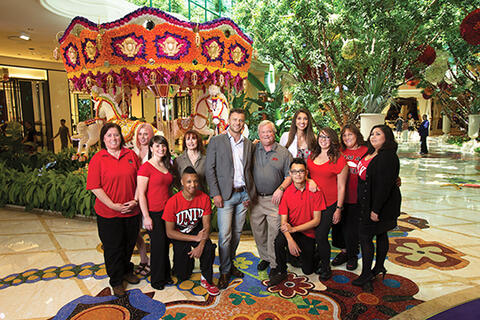 A group of people standing in a casino lobby