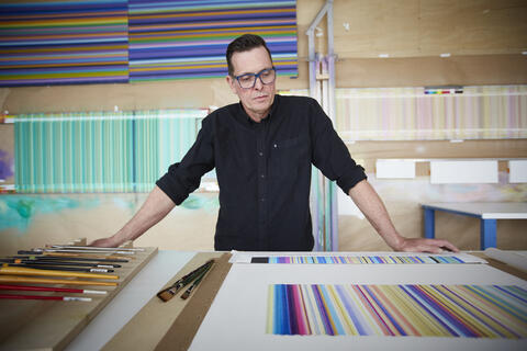 Tim Bavington poses in his studio