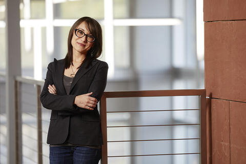 brandi planet standing with arms folded