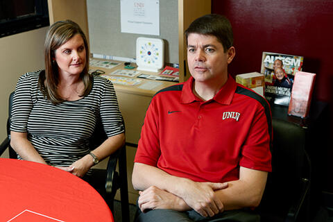 A woman and man sitting down in an office