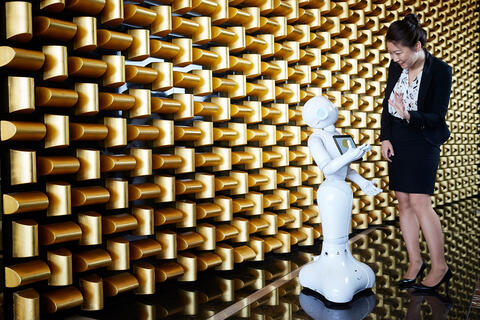 Beth Wi waves to robot Pepper